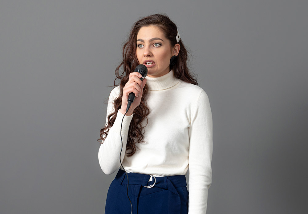 attractive-female-conference-speaker-during-presen-JFHMA4Jjpg